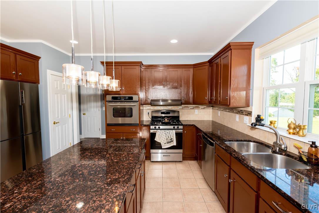 140 Fox Ridge Nazareth, PA 18064 - Photo 8 of 24 a kitchen with stainless steel appliances granite countertop a sink a stove and refrigerator