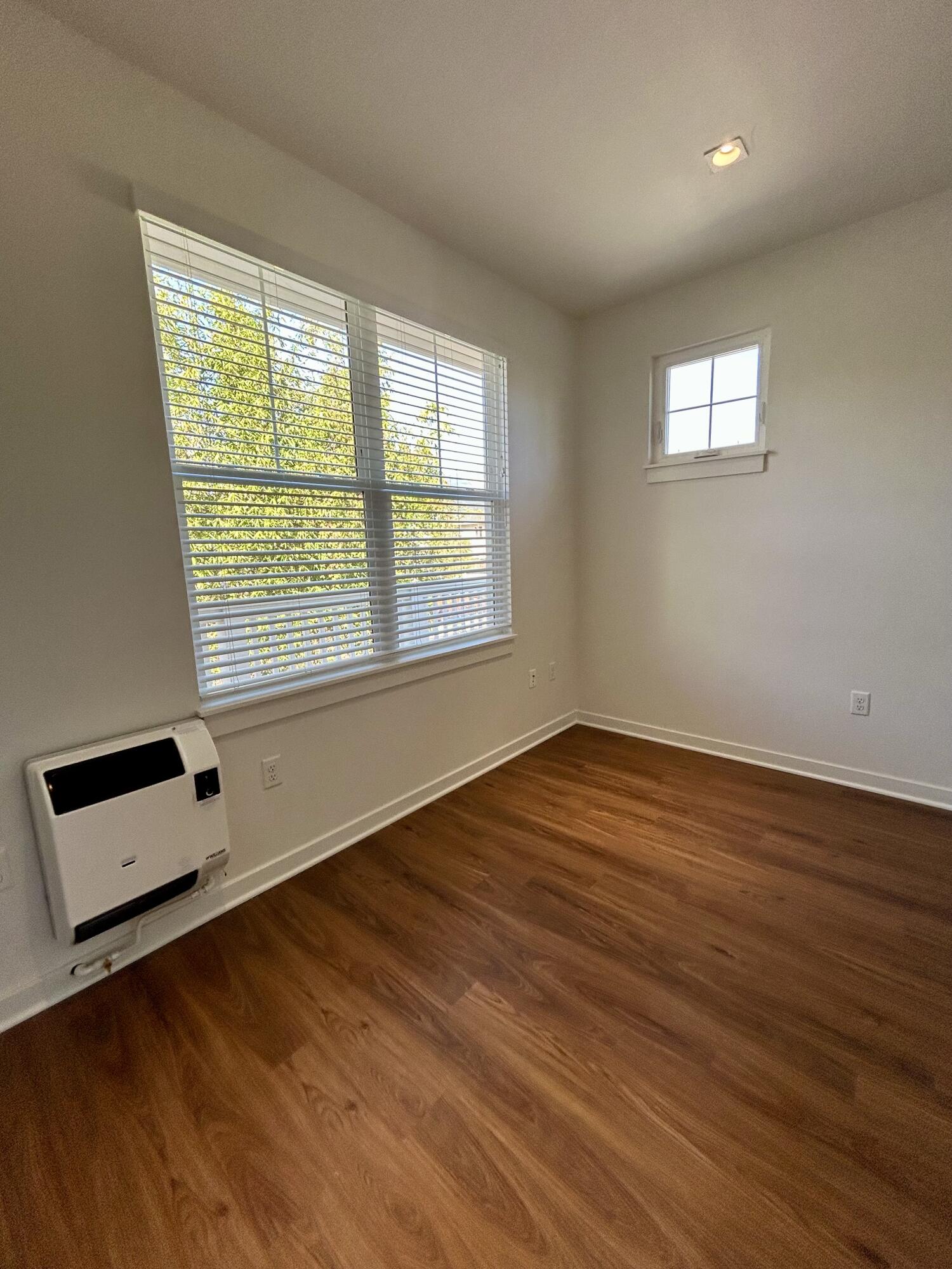 1518 Castillo Street, Unit C Santa Barbara, CA 93101 - Photo 11 of 13 a view of an empty room with wooden floor and a window
