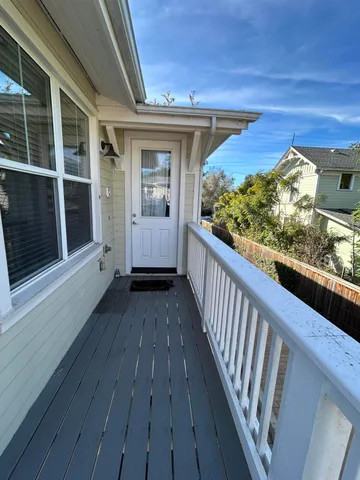 a view of a balcony with wooden floor