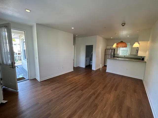 a view of a kitchen with wooden floor and a sink