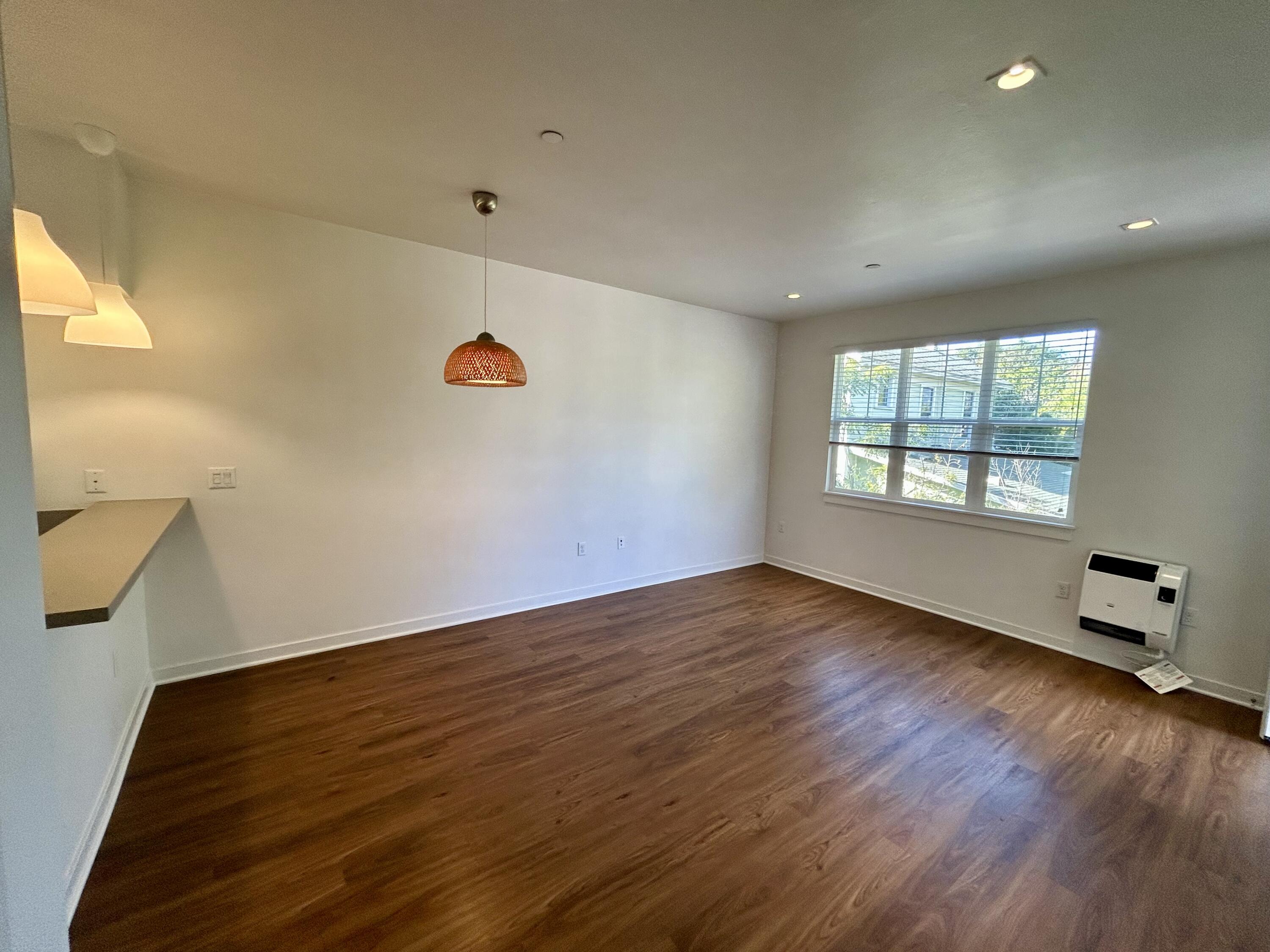 1518 Castillo Street, Unit C Santa Barbara, CA 93101 - Photo 4 of 13 an empty room with wooden floor and windows