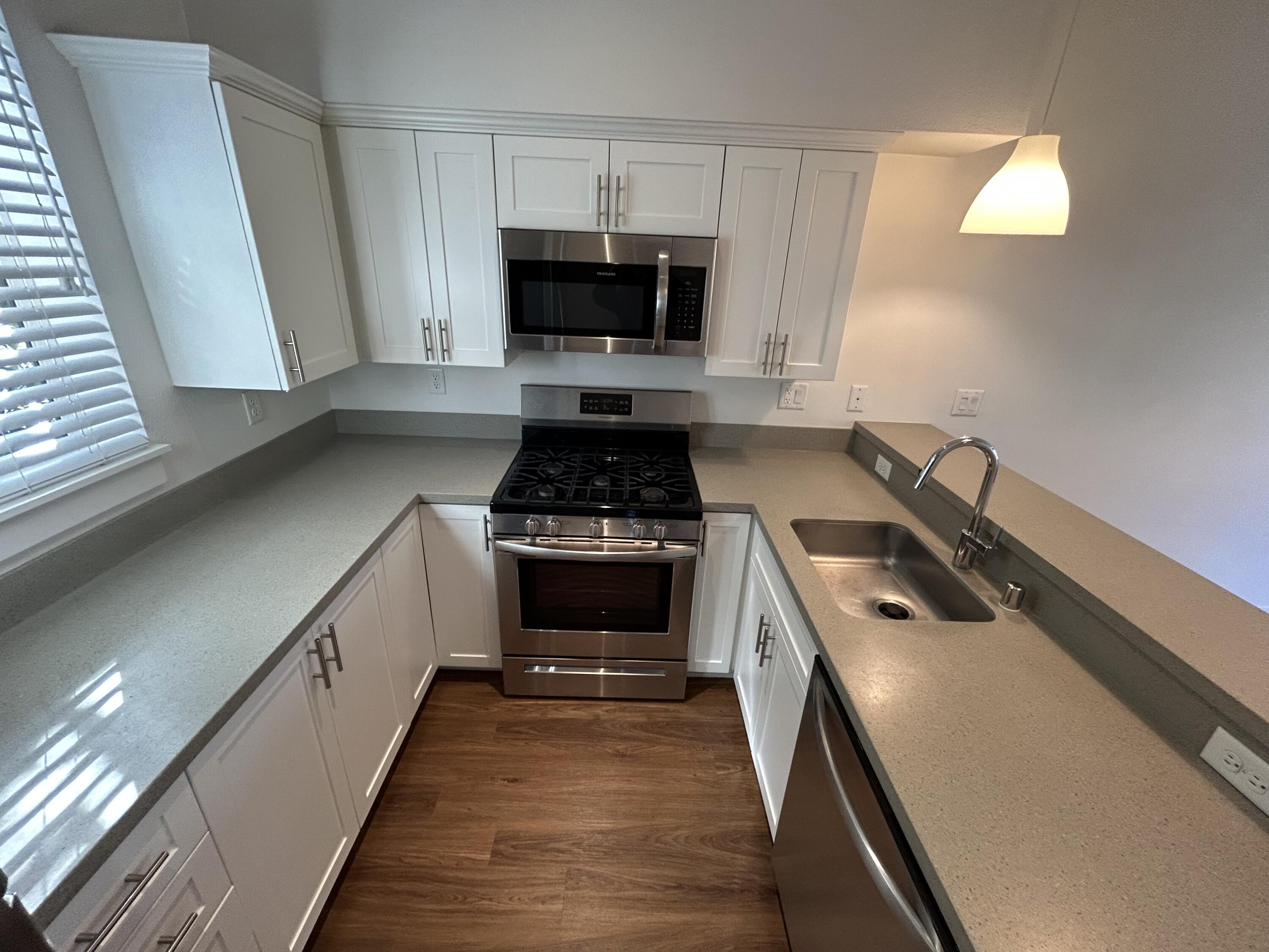 1518 Castillo Street, Unit C Santa Barbara, CA 93101 - Photo 7 of 13 a kitchen with sink a microwave a stove and cabinets