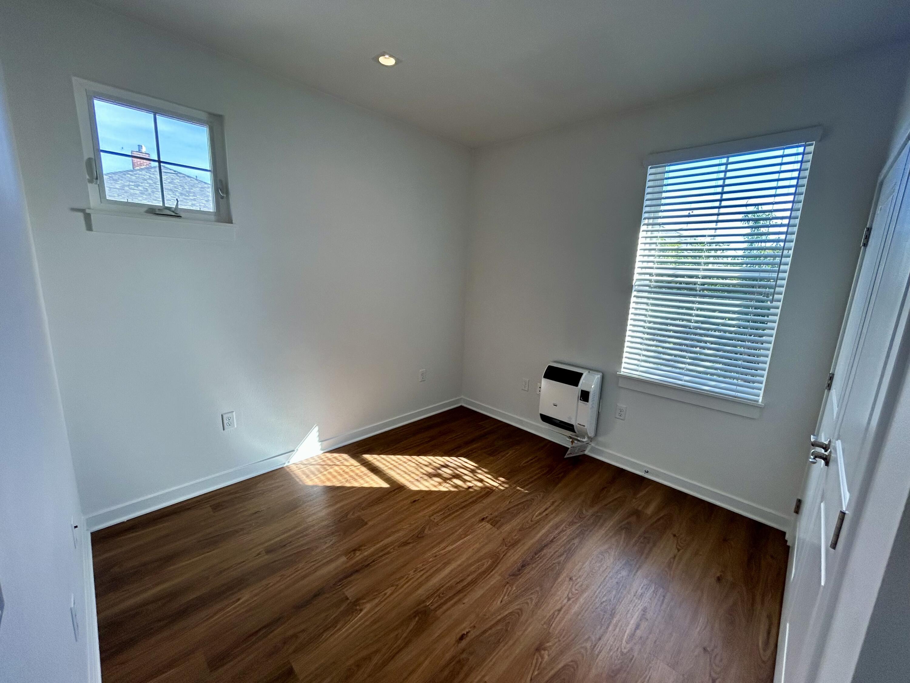 1518 Castillo Street, Unit C Santa Barbara, CA 93101 - Photo 8 of 13 a view of an empty room with wooden floor and a window
