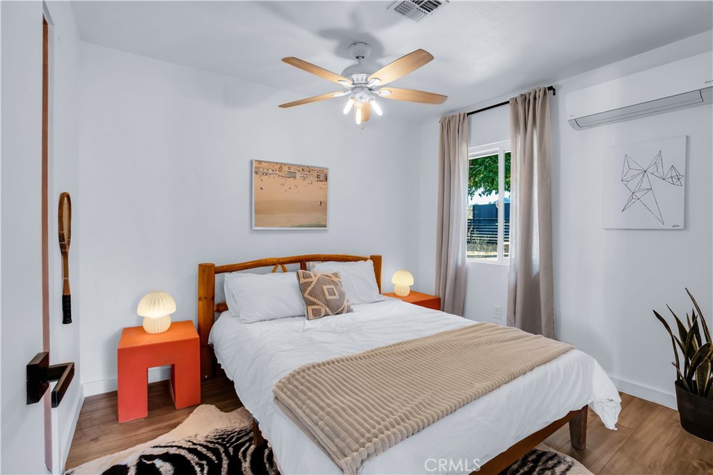 60670 Pueblo Trail Joshua Tree, CA 92252 - Photo 6 of 14 a bedroom with a bed and a chandelier