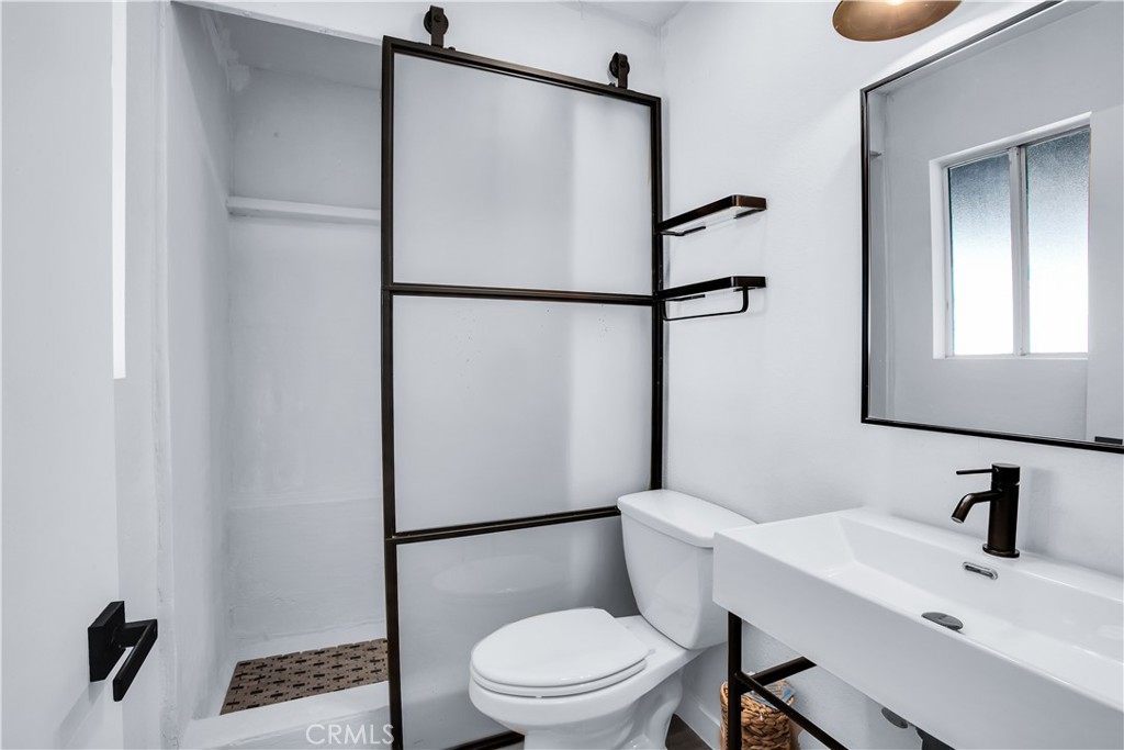 60670 Pueblo Trail Joshua Tree, CA 92252 - Photo 7 of 14 a bathroom with a toilet a sink and shower