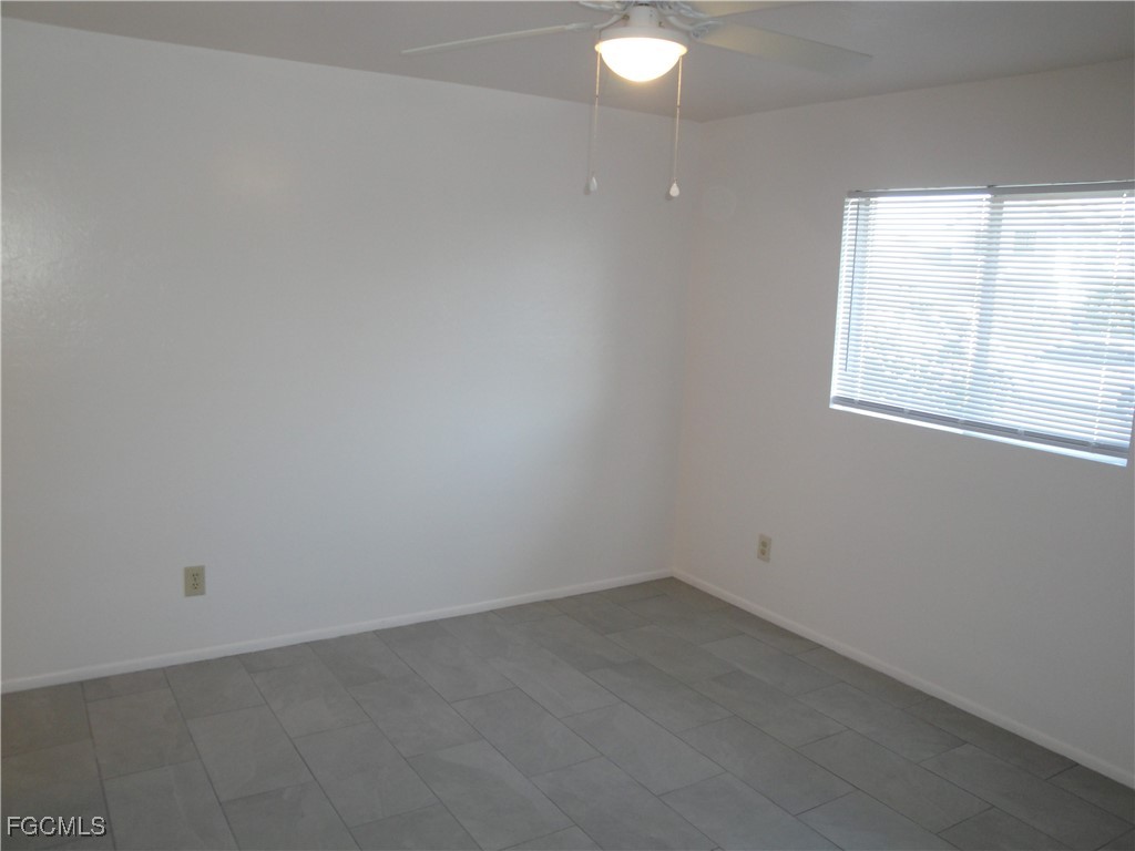 7487 Mellon Road Fort Myers, FL 33967 - Photo 3 of 10 an empty room with a window