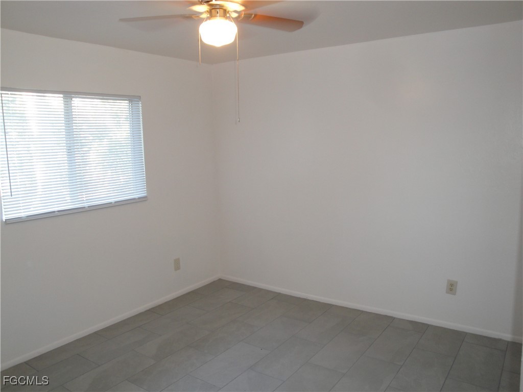 7487 Mellon Road Fort Myers, FL 33967 - Photo 4 of 10 an empty room with a window