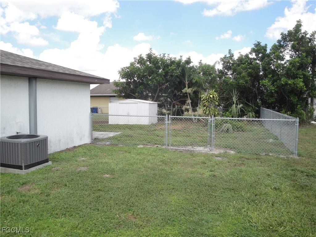 7487 Mellon Road Fort Myers, FL 33967 - Photo 7 of 10 a backyard of a house with lots of green space