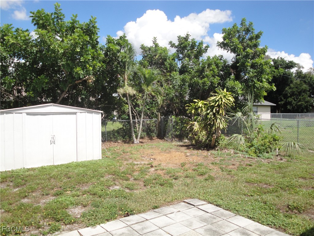 7487 Mellon Road Fort Myers, FL 33967 - Photo 9 of 10 a backyard of a house with lots of green space