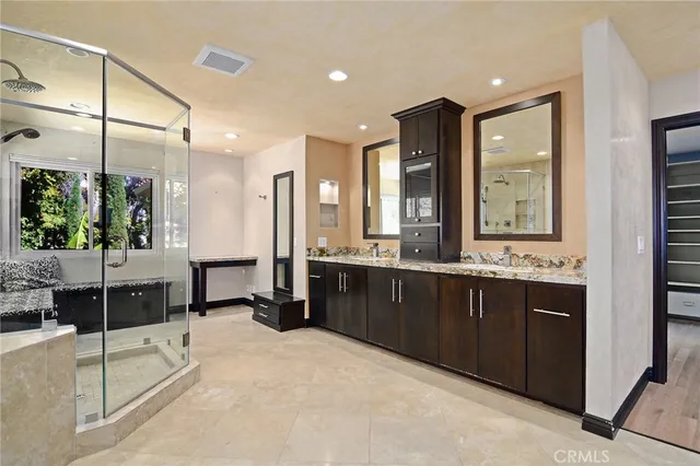 a large bathroom with a large tub and sink