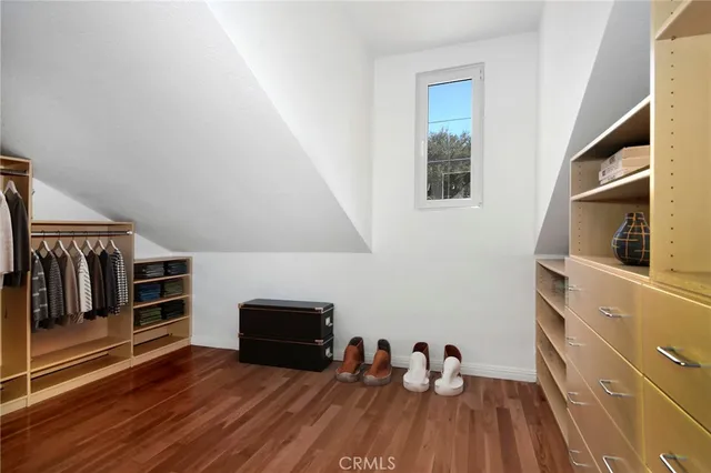 a view of a livingroom with wooden floor and furniture