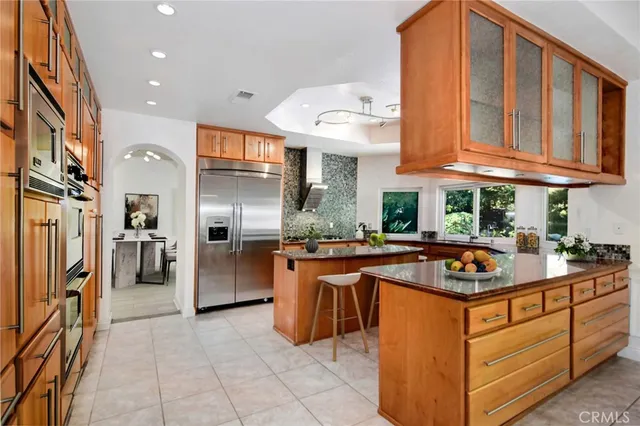 a kitchen with stainless steel appliances granite countertop a stove and a refrigerator