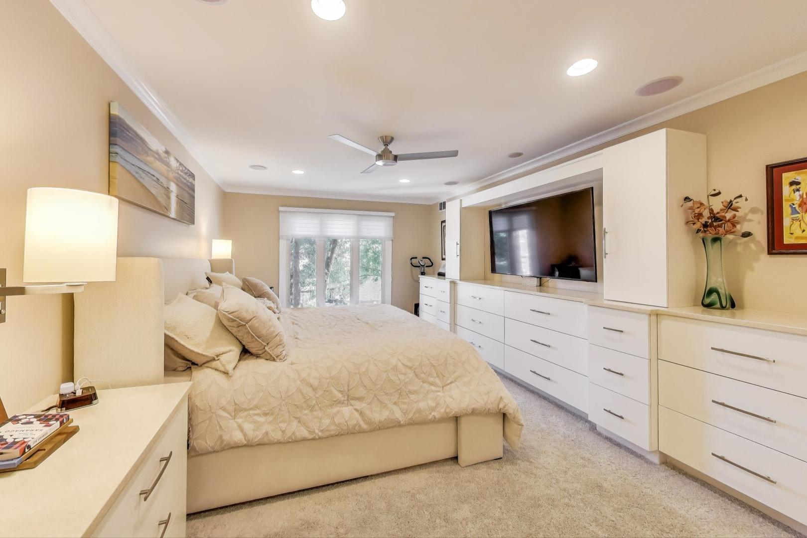 3810 Mission Hills Road, Unit 202 Northbrook, IL 60062 - Photo 13 of 25 a bedroom with a large bed and a flat tv screen on dresser