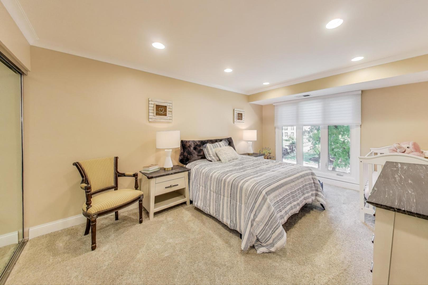 3810 Mission Hills Road, Unit 202 Northbrook, IL 60062 - Photo 17 of 25 a spacious bedroom with a bed and glass window