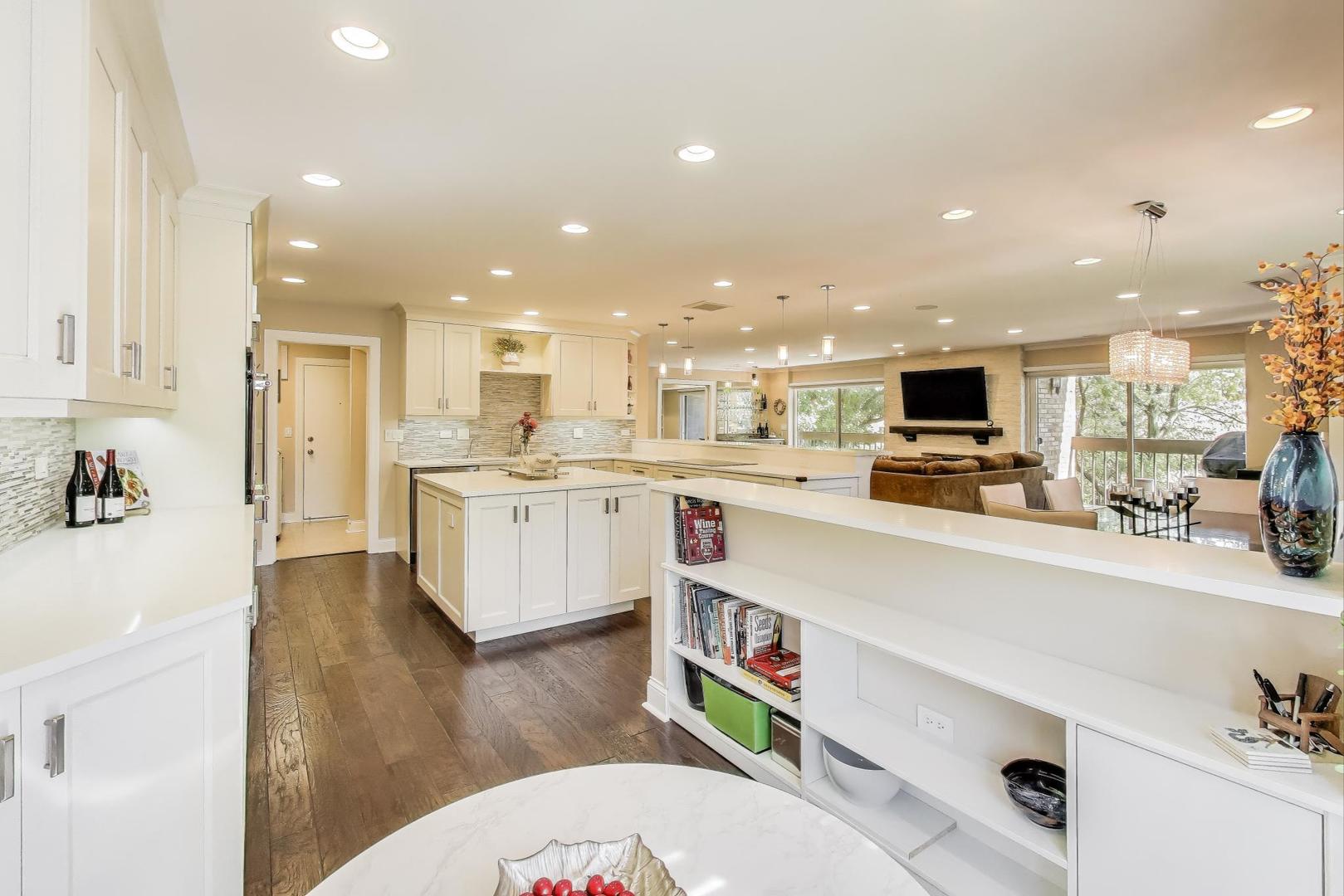 3810 Mission Hills Road, Unit 202 Northbrook, IL 60062 - Photo 18 of 25 a large white kitchen with lots of counter space wooden floor and appliances