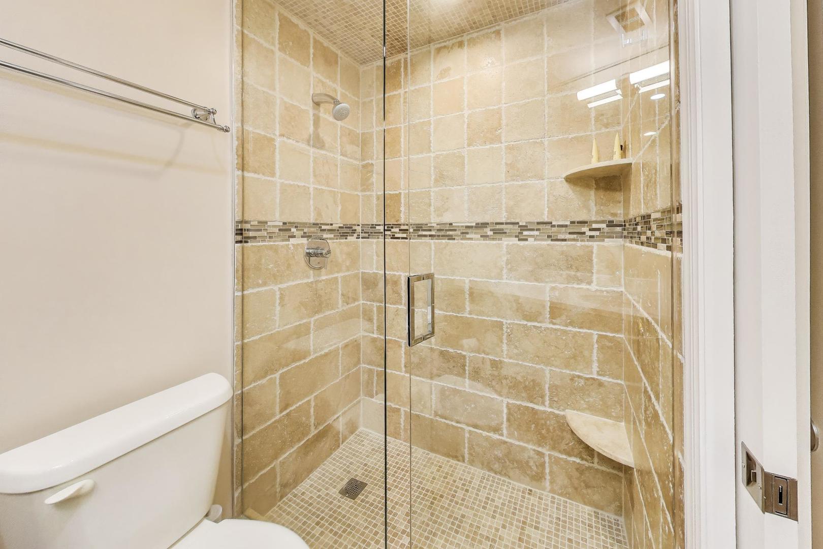 3810 Mission Hills Road, Unit 202 Northbrook, IL 60062 - Photo 20 of 25 a bathroom with a shower and a toilet