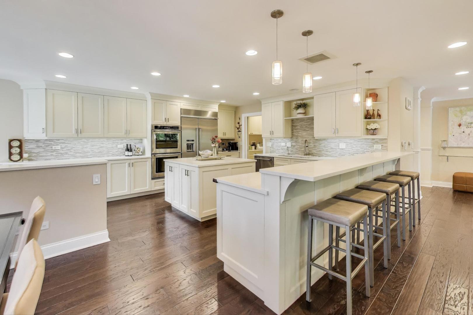 3810 Mission Hills Road, Unit 202 Northbrook, IL 60062 - Photo 6 of 25 a large kitchen with kitchen island a sink and a stove top oven