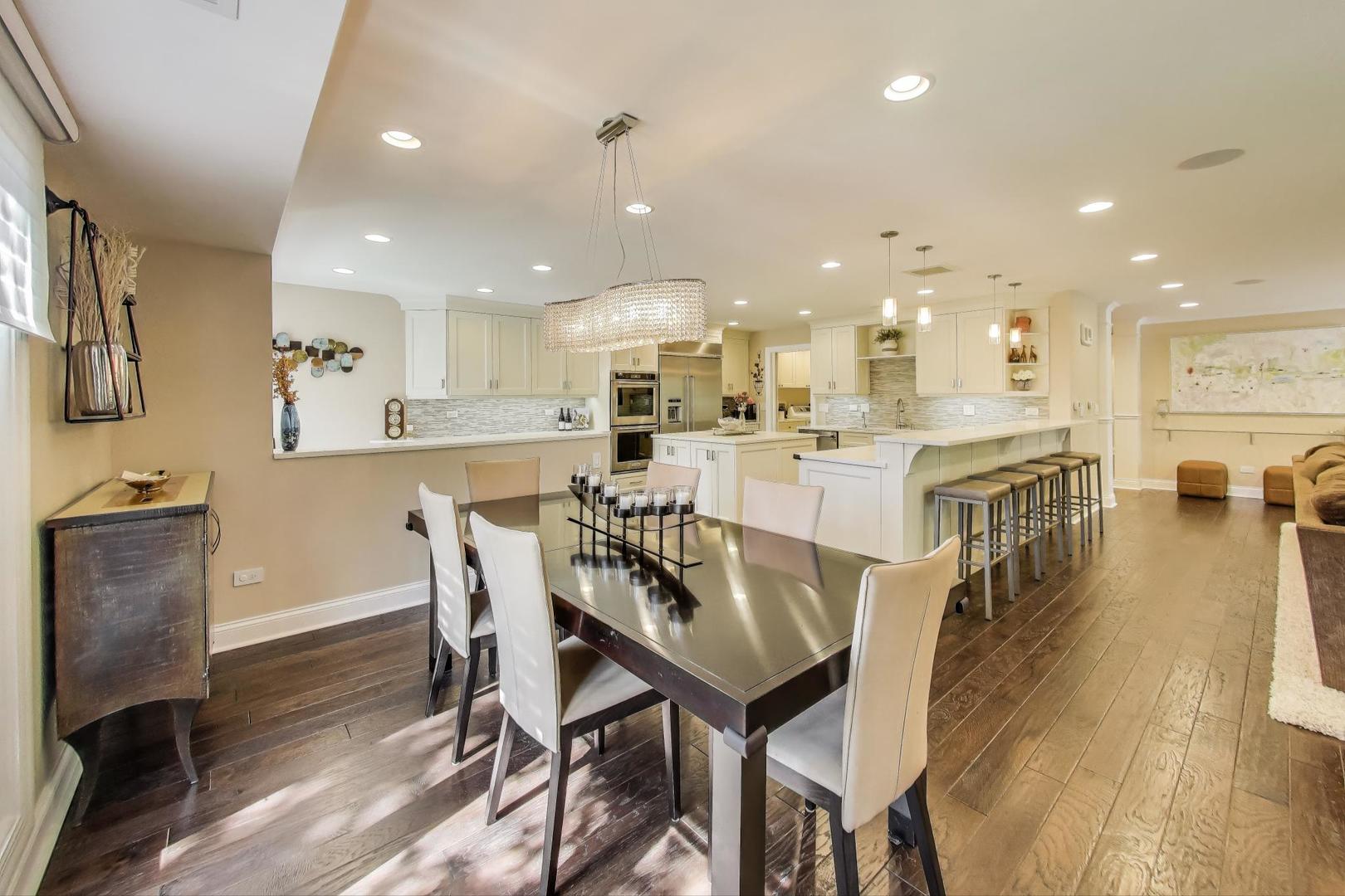 3810 Mission Hills Road, Unit 202 Northbrook, IL 60062 - Photo 7 of 25 a view of a dining area with furniture wooden floor and a kitchen
