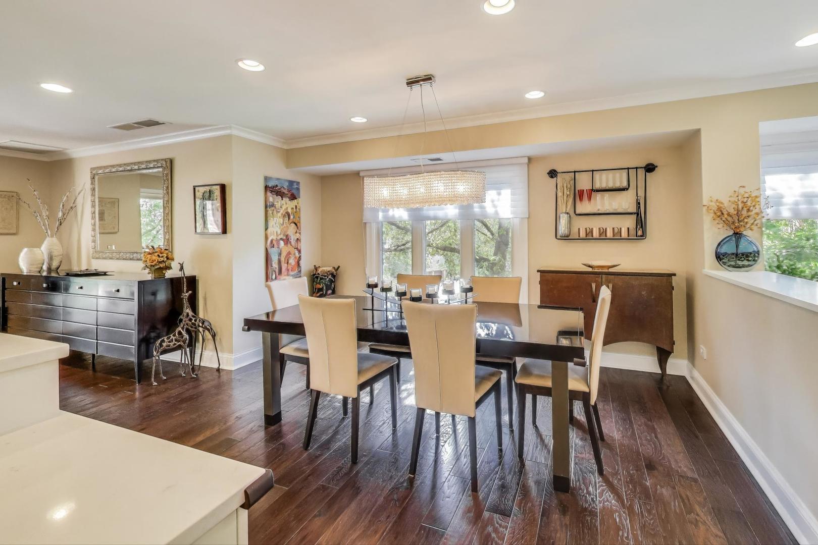 3810 Mission Hills Road, Unit 202 Northbrook, IL 60062 - Photo 8 of 25 a view of a dining room with furniture and wooden floor