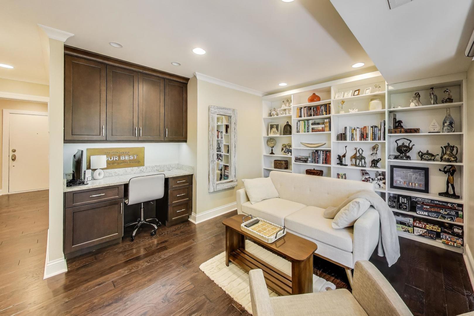 3810 Mission Hills Road, Unit 202 Northbrook, IL 60062 - Photo 10 of 25 a living room with furniture a fireplace and a book shelf