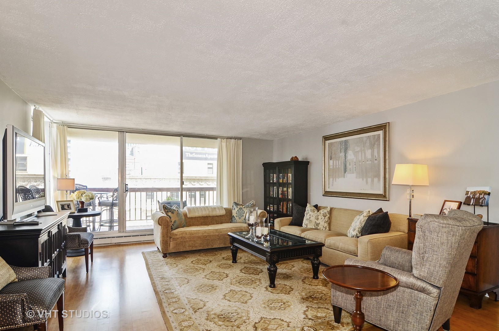 201 East Chestnut Street, Unit 20A Chicago, IL 60611 - Photo 2 of 13 a living room with furniture and a large window with wooden floor