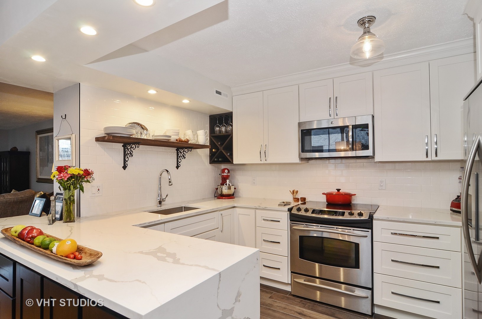 201 East Chestnut Street, Unit 20A Chicago, IL 60611 - Photo 4 of 13 a kitchen with kitchen island white cabinets and appliances