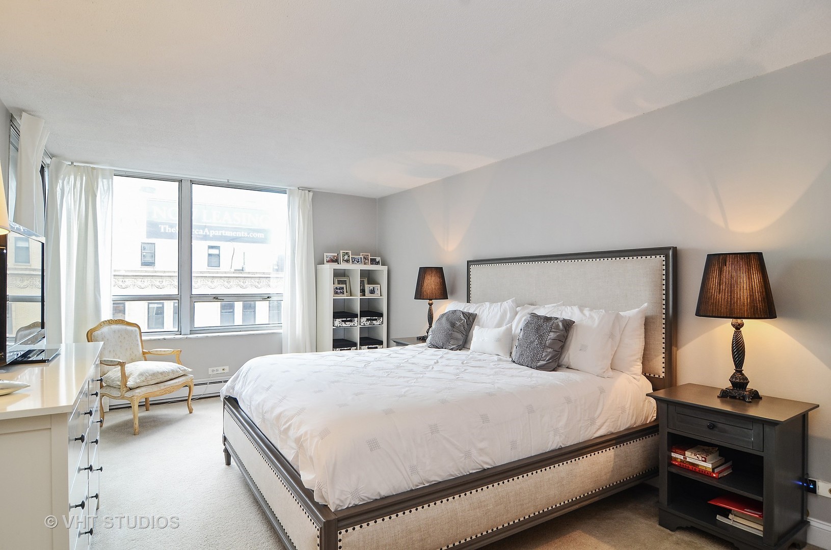 201 East Chestnut Street, Unit 20A Chicago, IL 60611 - Photo 6 of 13 a bedroom with a bed and a lamp next to a window