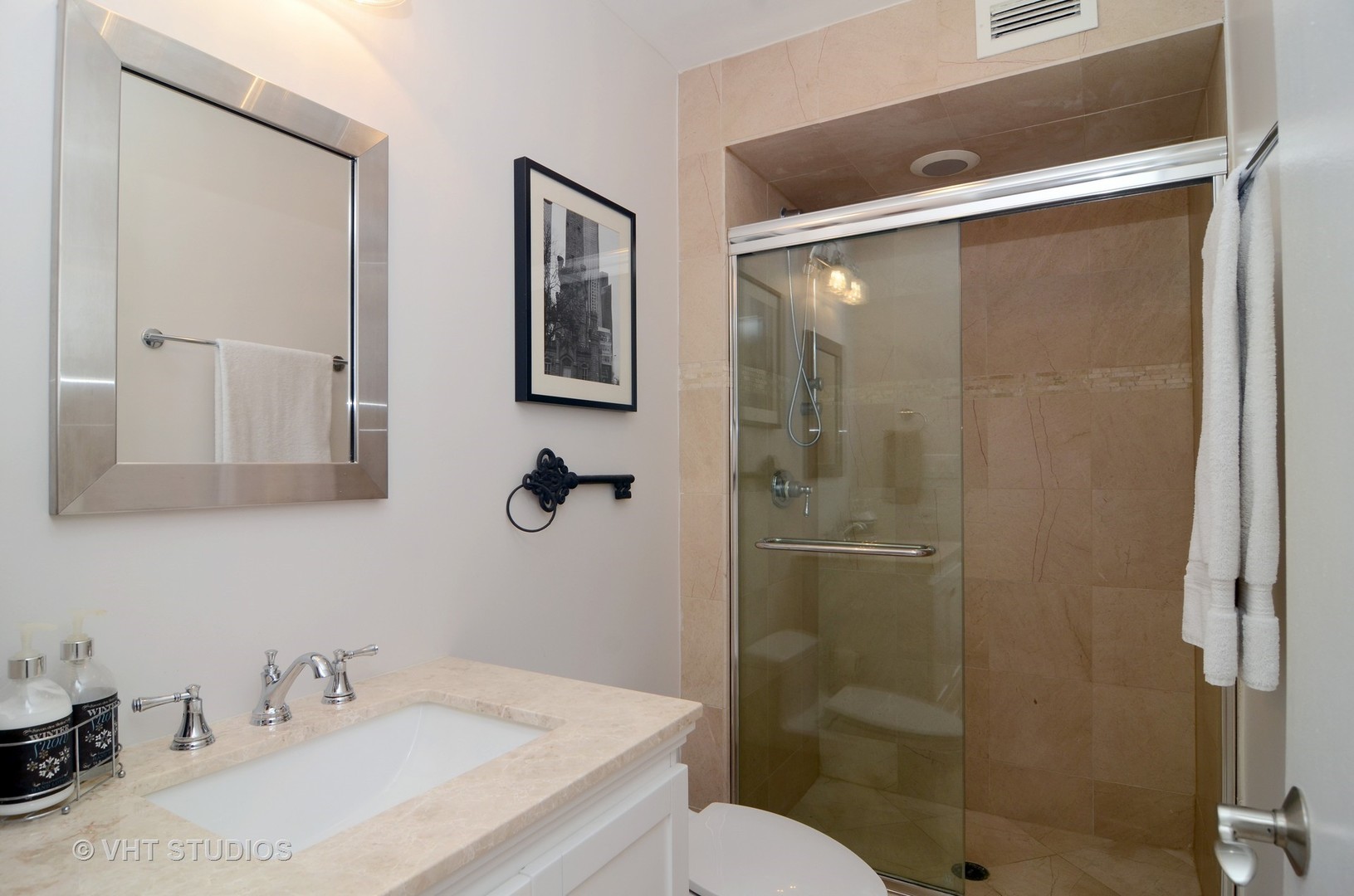 201 East Chestnut Street, Unit 20A Chicago, IL 60611 - Photo 9 of 13 a bathroom with a sink toilet and shower