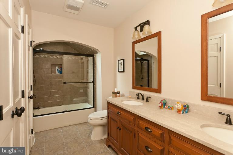 7 Roland Court Towson, MD 21204 - Photo 19 of 25 a bathroom with a double vanity sink mirror and shower