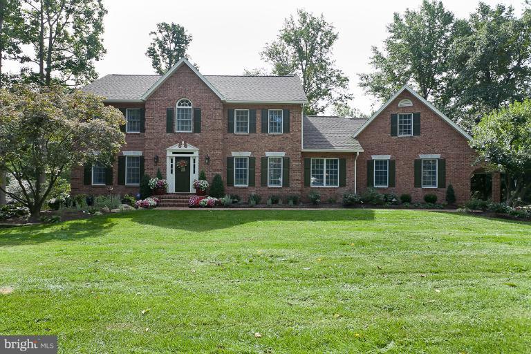7 Roland Court Towson, MD 21204 - Photo 25 of 25 a front view of a house with a garden and trees