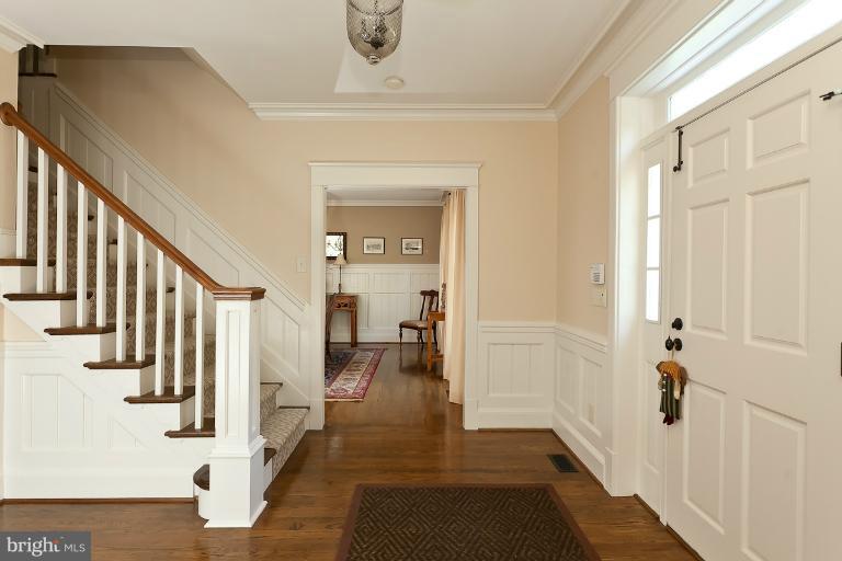 7 Roland Court Towson, MD 21204 - Photo 8 of 25 a view of a hallway with wooden floor and staircase