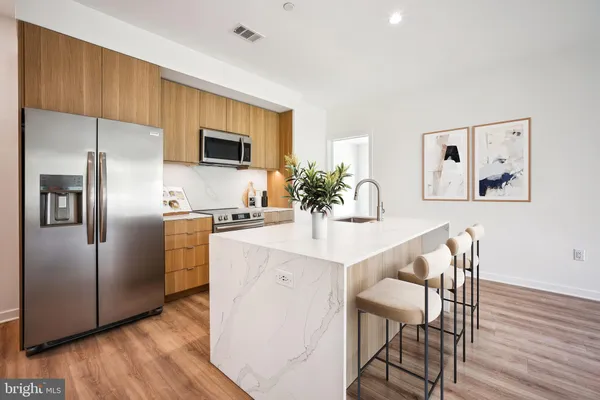 a kitchen with stainless steel appliances a refrigerator and a stove top oven