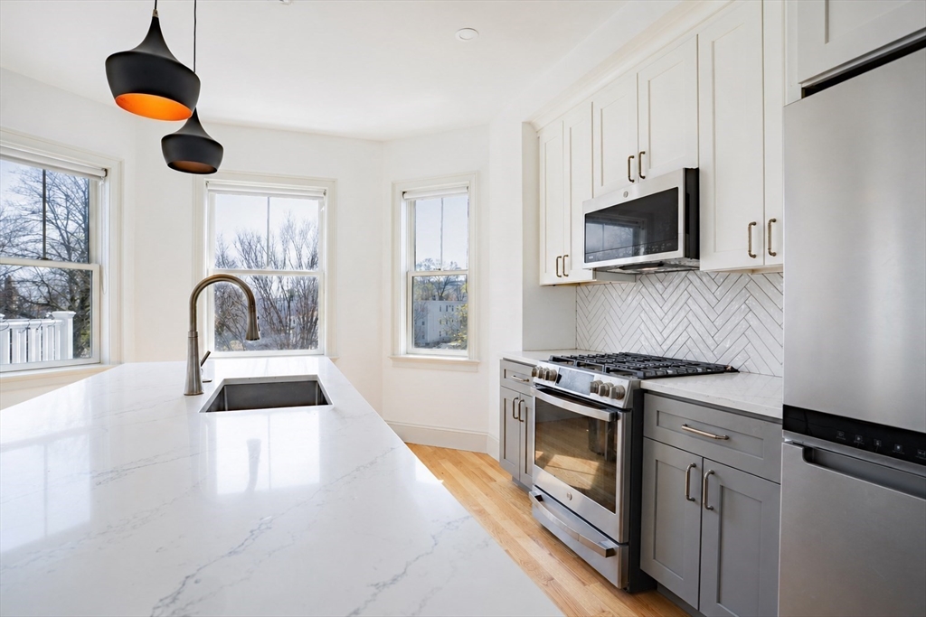 16 Church Street Boston, MA 02122 - Photo 14 of 23 a kitchen with a stove and a sink