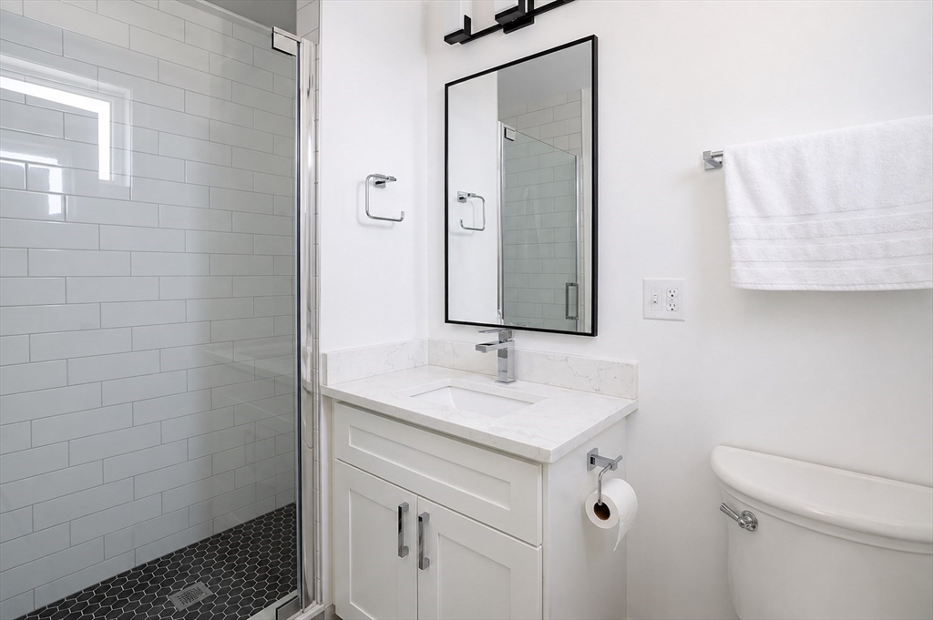 16 Church Street Boston, MA 02122 - Photo 17 of 23 a bathroom with a sink and a mirror