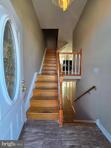 a view of entryway with wooden floor and a front door