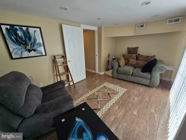 a living room with furniture and a rug
