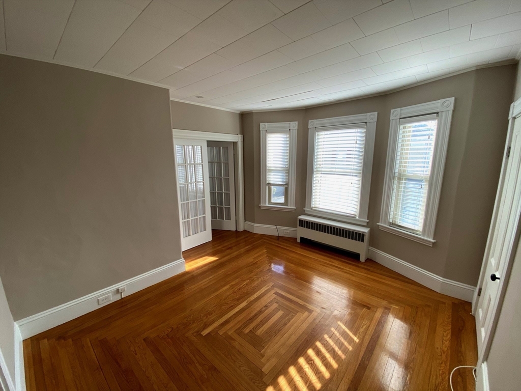 36 Stone Street Beverly, MA 01915 - Photo 21 of 42 a view of an empty room with wooden floor and a window