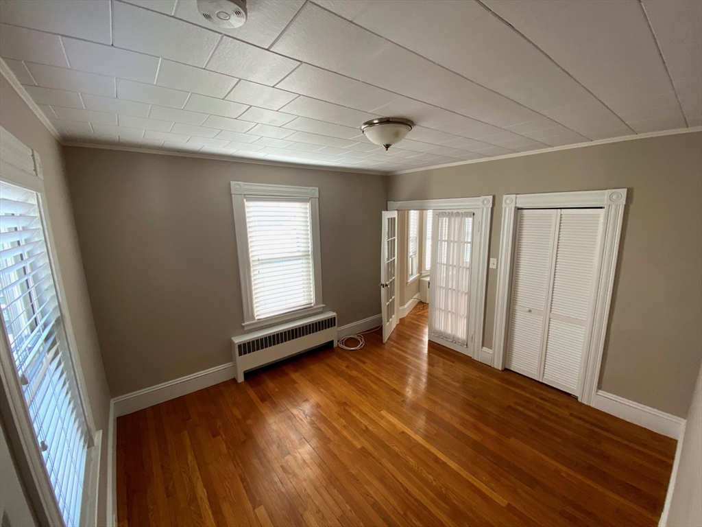 36 Stone Street Beverly, MA 01915 - Photo 23 of 42 a view of an empty room with wooden floor and a window
