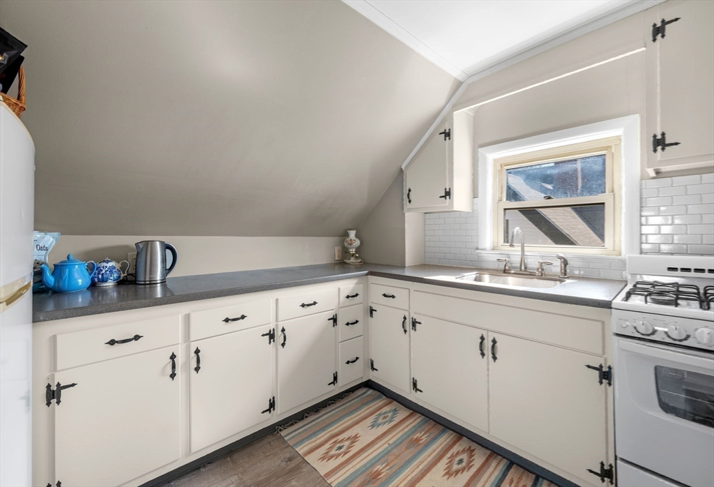 36 Stone Street Beverly, MA 01915 - Photo 27 of 42 a kitchen with granite countertop white cabinets and white appliances