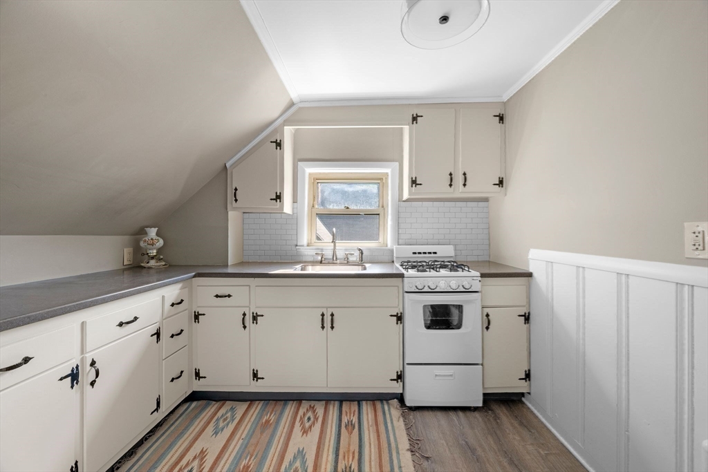 36 Stone Street Beverly, MA 01915 - Photo 28 of 42 a kitchen with granite countertop white cabinets and white appliances