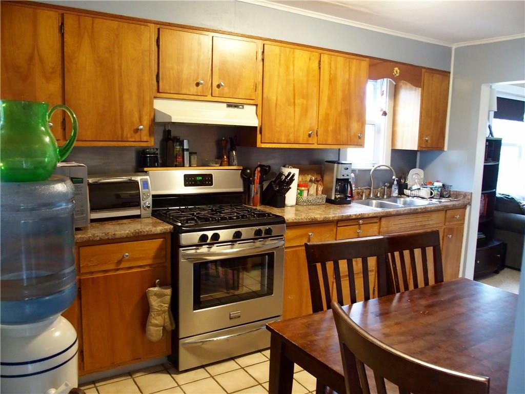 Kitchen with updated counter tops, stainless, and titanium backsplash.