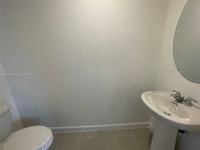 a bathroom with a sink mirror and toilet