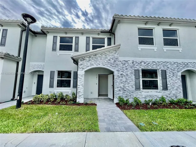 a front view of a house with garden