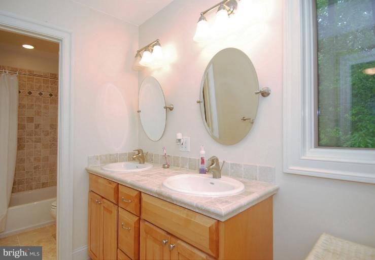 600 Utterback Store Road Great Falls, VA 22066 - Photo 22 of 30 a bathroom with a sink and a mirror