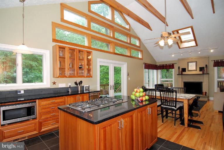 600 Utterback Store Road Great Falls, VA 22066 - Photo 5 of 30 a kitchen that has a table chairs and a stove
