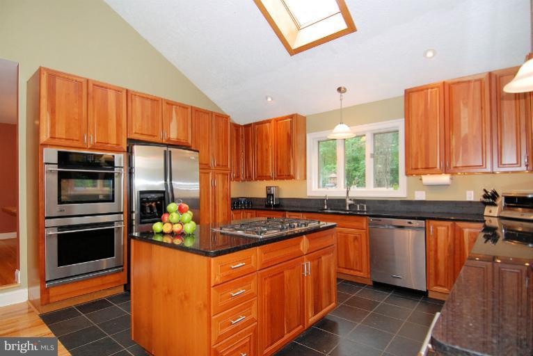 600 Utterback Store Road Great Falls, VA 22066 - Photo 6 of 30 a kitchen with stainless steel appliances granite countertop a stove a sink dishwasher and a refrigerator