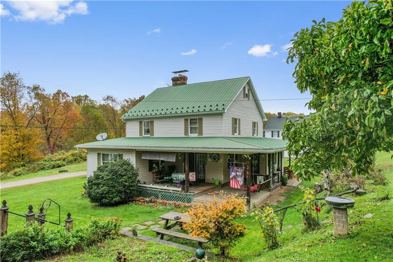 a view of house with yard and green space