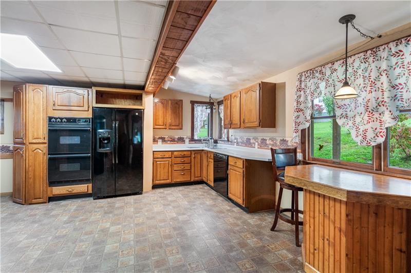 218 Outcrop Road Smithfield, PA 15478 - Photo 12 of 21 a large kitchen with stainless steel appliances granite countertop a refrigerator and a stove top oven