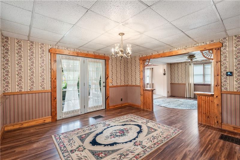 218 Outcrop Road Smithfield, PA 15478 - Photo 13 of 21 a view of a hallway with wooden floor and a chandelier
