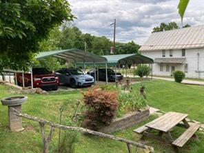 218 Outcrop Road Smithfield, PA 15478 - Photo 6 of 21 a view of a patio with table and chairs potted plants and a palm tree